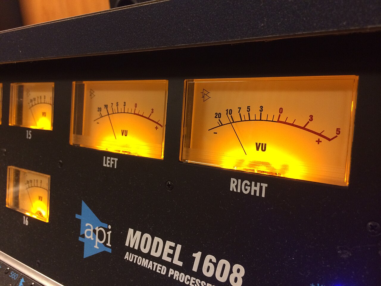 The meter bridge and channel strips of an API 1608 recording console.