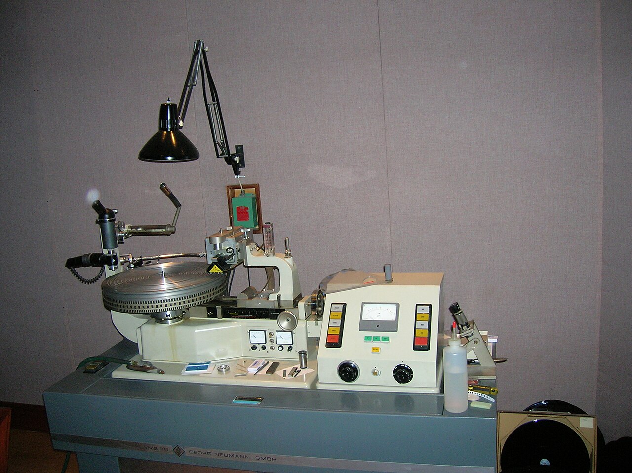 A Neumann VMS-70 disc cutting lathe with a lacquer on the platter.