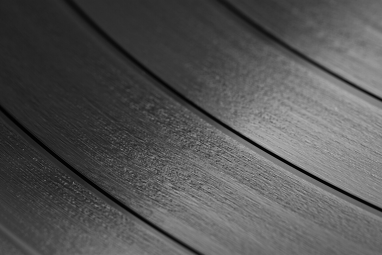 Macro photograph of the grooves on a 12-inch vinyl LP.